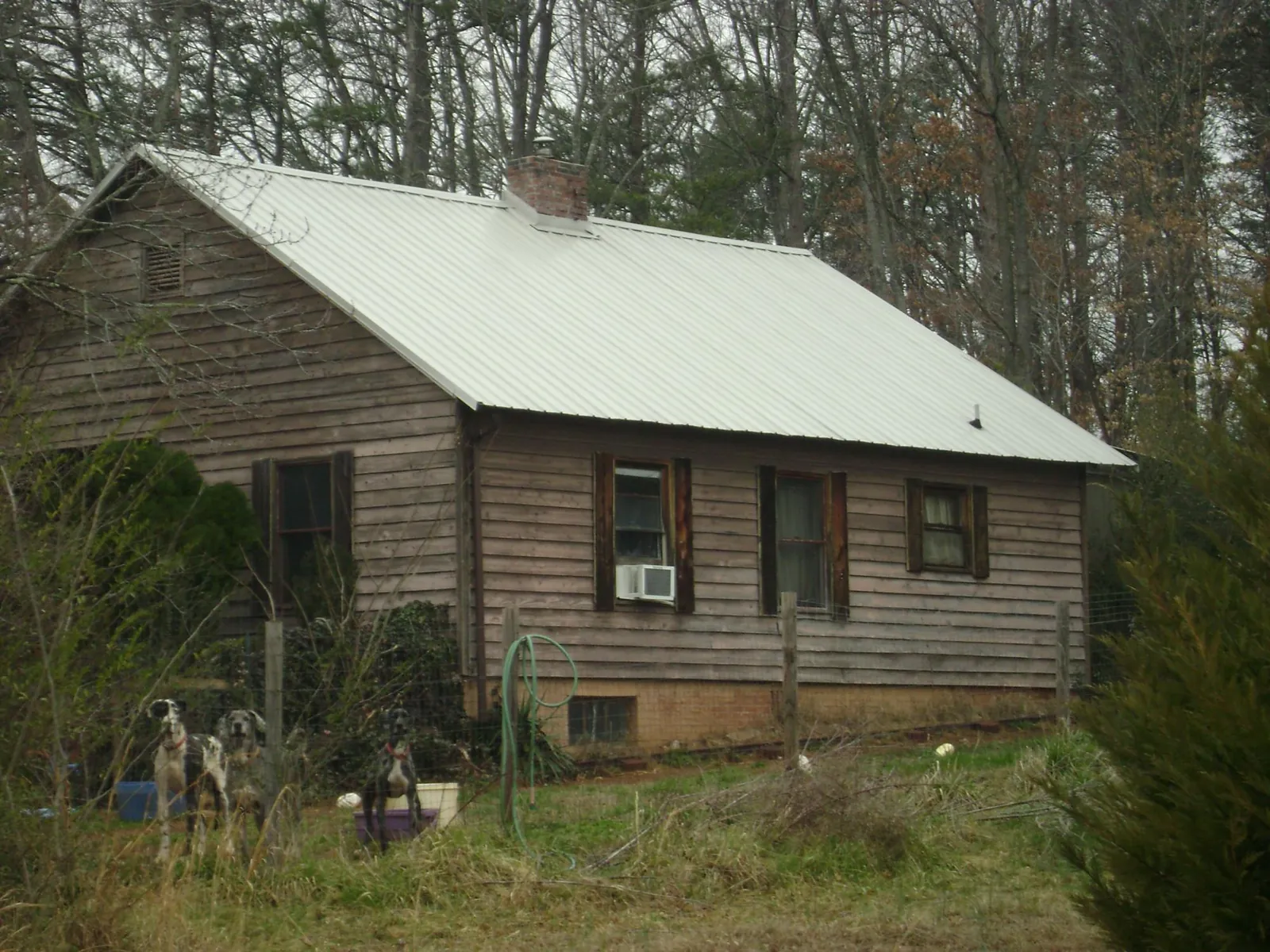 White metal roof on an old wood sided farmhouse, from a Asphalt Shingle Roof Repair job in Newark